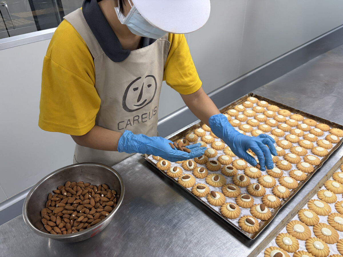▲喜憨兒庇護工場正在製作年節產品，每道工序都有憨兒參與。（圖/喜憨兒基金會提供）