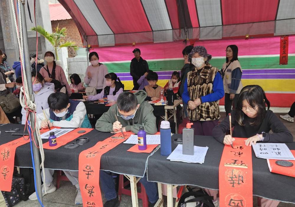 民雄鄉公所為營造溫馨喜氣的年節氛圍並推廣書法藝術，辦2026「駿馬奔騰迎新春，妙筆生花寫春聯」新春揮毫，並免費致贈春聯活動。（圖/民雄鄉公所提供）